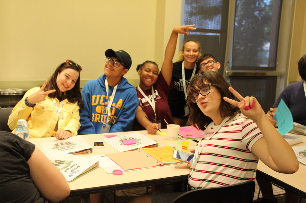 2018 campers from NorCal and the Central Valley smiling at the camera while sitting at a table