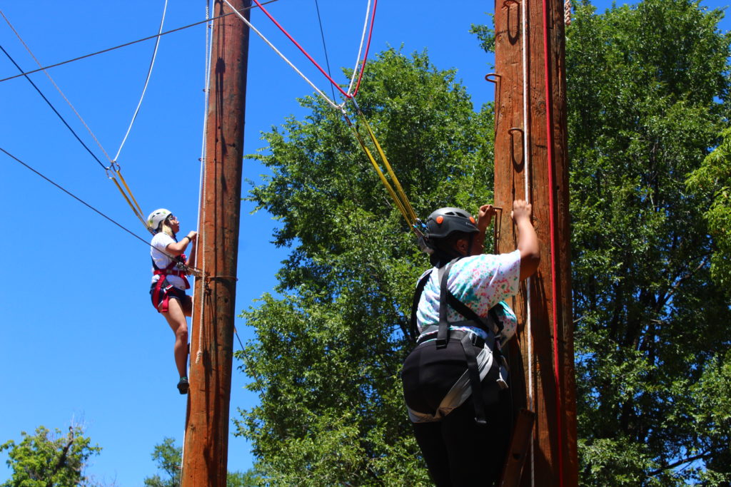 LGBTQ youth climbing during ropes course